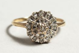 A 9CT GOLD DIAMOND CLUSTER RING.