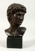 A GRAND TOUR BRONZE BUST on a marble plinth. 5ins high.