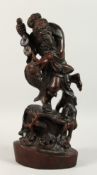 A CHINESE CARVED WOOD FISHERMAN holding a carp. 18ins high.