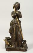 A GOOD SMALL BRONZE OF A SHEPHERDESS, a dog at her side. 7ins high.