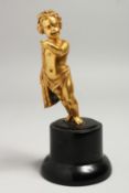 A GOOD SMALL 19TH CENTURY GILT BRONZE CUPID on a circular plinth. 12cm high.
