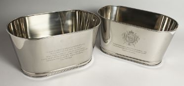 A SMALL PAIR OF LILY BOLLINGER OVAL SILVER-PLATED WINE COOLERS. 25ins long.