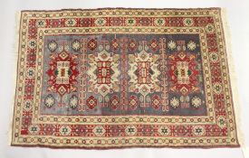 A PERSIAN RUG, cream ground with four large central medallions. 6ft 8ins x 4ft 5ins.