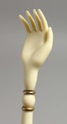 A 19TH CENTURY EUROPEAN IVORY CARVED BACK SCRATCHER, one end with a hand, the other with bobbin type