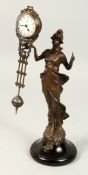 A BRONZED DIANA SWING CLOCK on a circular wooden base, 12ins high.
