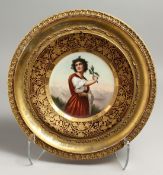 A GOOD 19TH CENTURY VIENNA PORCELAIN CIRCULAR PLATE OF DISTEL, holding a piece of holly. Beehive