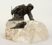 A VERY GOOD RUSSIAN ROCK CRYSTAL AND BRONZE GROUP depicting a man with a seal. 6.5ins long 5ins