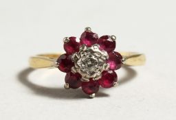 AN 18CT GOLD RUBY AND DIAMOND CLUSTER RING.