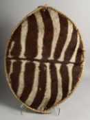 A ZEBRA HIDE ZULU SHIELD 26ins x 18ins.