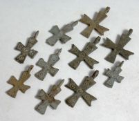 TEN SMALL ROMAN IRON CROSSES, 3/4ins.