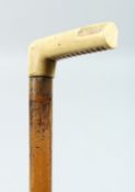A WALKING STICK with bone handle. 33ins long.