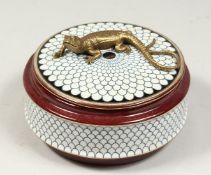 A PORCELAIN CIRCULAR BOX AND COVER the lid with a bronze lizard. 5ins diameter.