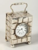A MINIATURE VICTORIAN SILVER CASED CLOCK with carrying handles on four ball feet. Birmingham 1892.