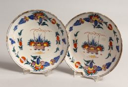 A PAIR OF 18TH CENTURY DUTCH DELFT TIN GLAZED PLATES with coloured enamels. 8.5ins diameter.