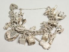 A GOOD SILVER CHARM BRACELET, 20 CHARMS 77grams.