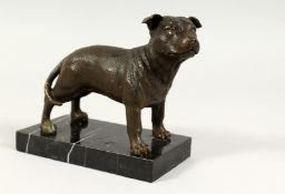 A SMALL BRONZE DOG on a marble base. 6ins long,
