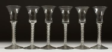 A SET OF SIX WINE GLASSES with inverted bell bowls and white opaque stems