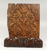 A 17TH CENTURY WALNUT CARVED TULIP PATTERN PANEL. 15ins x 12ins and a CHAIR TOP RAIL with crown 4ins