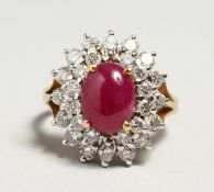 A GOLD CABOCHON RUBY AND DIAMOND CLUSTER RING.