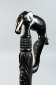 A CEYLONESE EBONY WALKING STICK with elephant handle 32ins long.