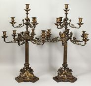 A VERY GOOD PAIR OF TEN LIGHT, BRONZE CLASSICAL CANDELABRA with column supports. scrolling arms,