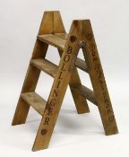 A SET OF FOLDING STEPS 'BOLLINGER & DOM PERIGNON' 34ins high closed.