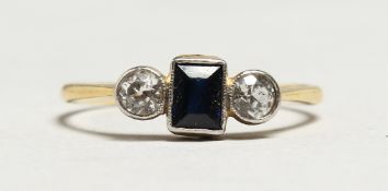 AN 18CT GOLD THREE STONE SAPPHIRE AND DIAMOND RING.
