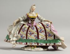 A GOOD CONTINENTAL PORCELAIN FIGURE OF A YOUNG LADY wearing a large dress, with flowers. 7.5ins