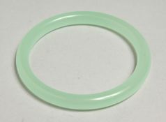 A GOOD ICY JADE BANGLE, 7cm diameter.