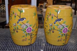 A pair of Chinese style barrel seats painted with birds on branches.