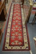 A Persian style red ground runner.