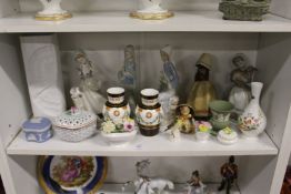 A shelf of decorative china to include Lladro and Rosenthal.