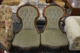 A pair of Victorian walnut framed button upholstered bedroom chairs.