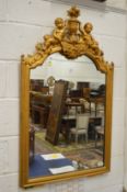 A 19th century gilt framed pier mirror with cherub and urn cresting.