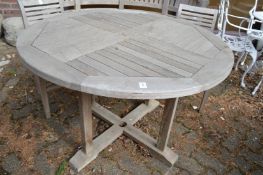 A circular teak garden table.