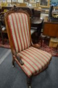 A Victorian walnut framed high-back upholstered bedroom chair.