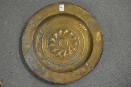 An embossed brass alms dish.