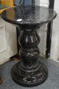 A heavy turned marble pedestal stand.