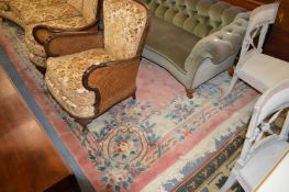 A large pink ground Chinese carpet.