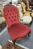 A Victorian carved walnut framed button upholstered nursing chair.