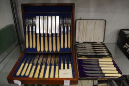 A mahogany cased twelve place fruit knife and fork set and two other sets of knives.