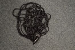 A designer necklace with original bag.