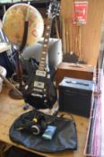 An Alba electric guitar complete with a Watson amplifier, headphones and accessories.