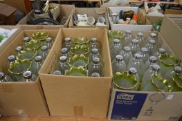 A large quantity of etched glass and green tinted lampshades.