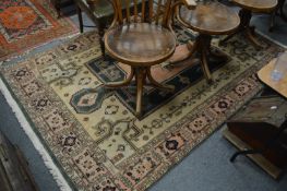 An eastern rug, cream ground with stylized decoration.