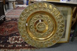 A good large, embossed brass circular charger.
