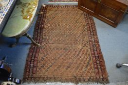 A small Persian rug (worn).