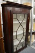 A mahogany hanging corner cupboard.