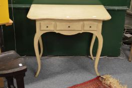 A painted three drawer side table.