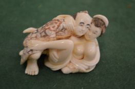 A carved erotic figure.